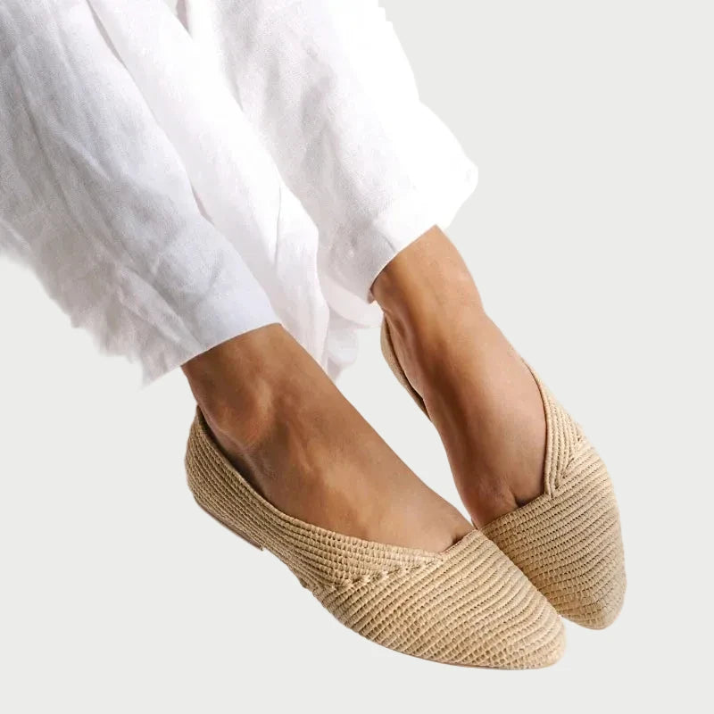 Model in white linen wearing Zineb handwoven raffia flats